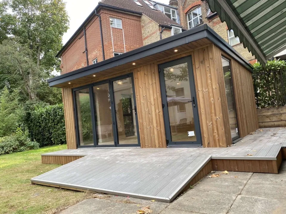 Cladded outdoor room with ramp up to the decking